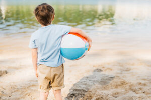 boy-with-wind-ball-looking-water boy-with-wind-ball-looking-water