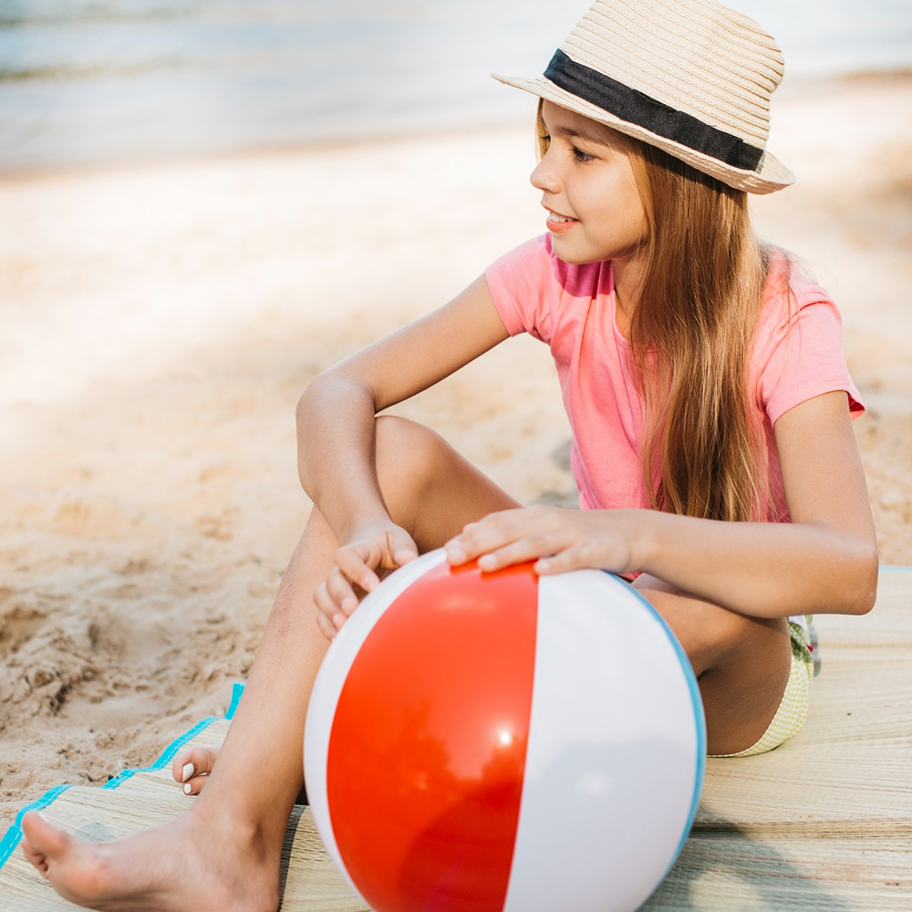 smiling-girl-with-wind-ball-beach